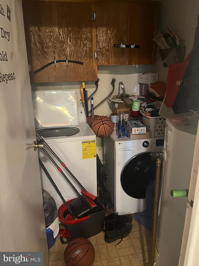 washroom with laundry area, washer / clothes dryer, tile patterned floors, and water heater