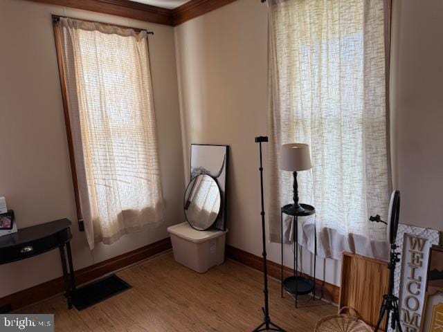 interior space featuring wood finished floors and baseboards