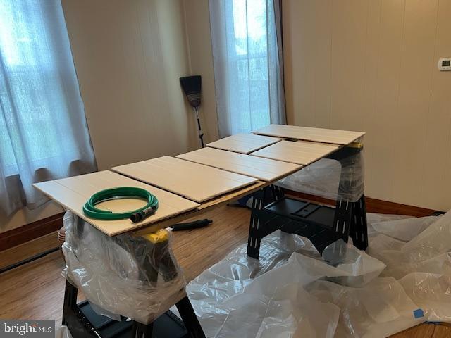 dining room with wood finished floors and a healthy amount of sunlight