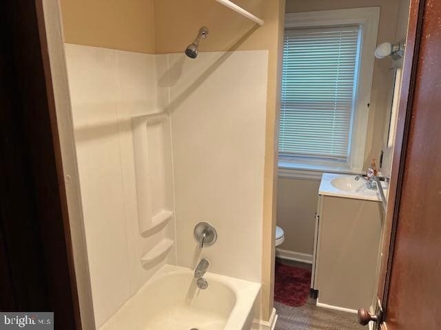 full bathroom with shower / bathing tub combination, vanity, toilet, and baseboards