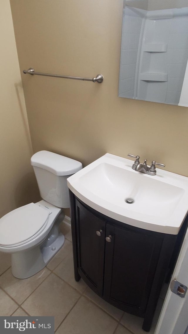 bathroom with tile patterned floors, vanity, and toilet