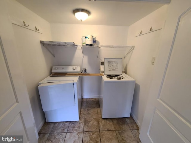 laundry area featuring baseboards, laundry area, and separate washer and dryer