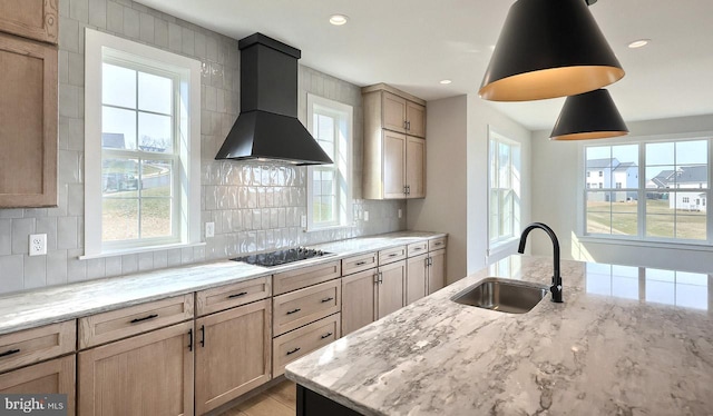 1999 N Fall Harvest Dr, Mechanicsburg, PA 17055 - kitchen with wall chimney exhaust hood, tasteful backsplash, light stone counters, a sink, and black electric cooktop