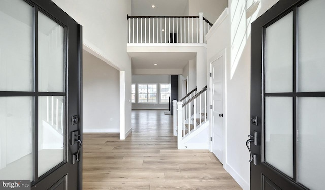 1999 N Fall Harvest Dr, Mechanicsburg, PA 17055 - entryway featuring baseboards, light wood-type flooring, a high ceiling, and stairway