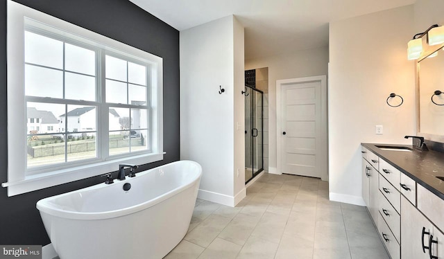 1999 N Fall Harvest Dr, Mechanicsburg, PA 17055 - full bath with baseboards, a shower stall, a freestanding tub, and vanity
