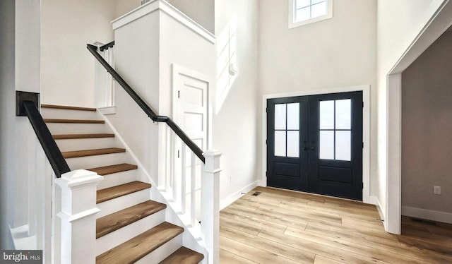 1999 N Fall Harvest Dr, Mechanicsburg, PA 17055 - foyer entrance featuring baseboards, french doors, a high ceiling, stairs, and wood finished floors