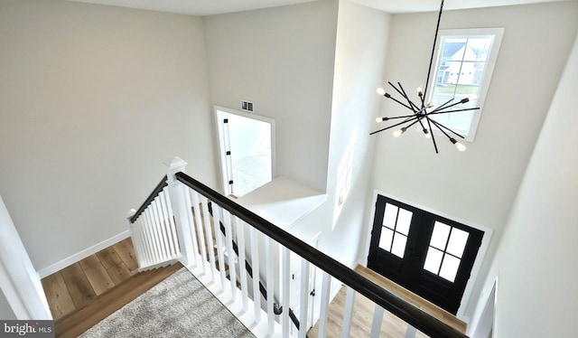 1999 N Fall Harvest Dr, Mechanicsburg, PA 17055 - staircase with visible vents, baseboards, a high ceiling, an inviting chandelier, and wood finished floors
