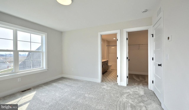 1999 N Fall Harvest Dr, Mechanicsburg, PA 17055 - unfurnished bedroom with visible vents, baseboards, a walk in closet, and light carpet