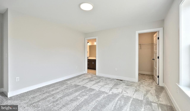 1999 N Fall Harvest Dr, Mechanicsburg, PA 17055 - unfurnished bedroom with light carpet, a closet, baseboards, and a walk in closet