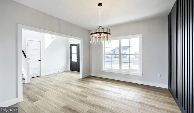 1999 N Fall Harvest Dr, Mechanicsburg, PA 17055 - unfurnished room featuring baseboards, light wood-type flooring, and a notable chandelier