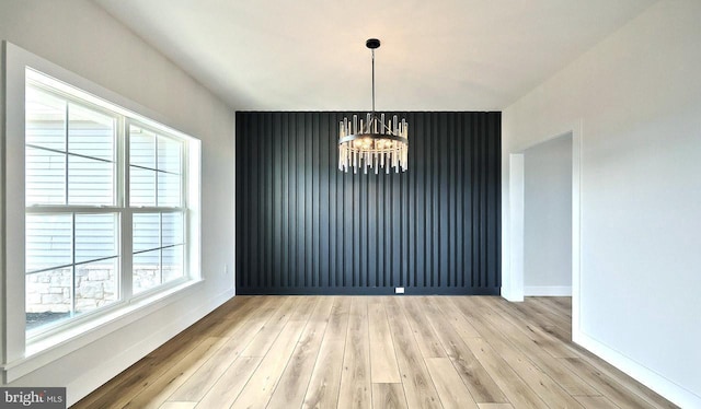 1999 N Fall Harvest Dr, Mechanicsburg, PA 17055 - unfurnished dining area featuring light wood-style floors, a notable chandelier, and baseboards