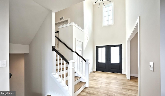 1999 N Fall Harvest Dr, Mechanicsburg, PA 17055 - entrance foyer with visible vents, baseboards, light wood finished floors, a towering ceiling, and french doors