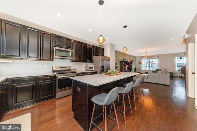 8473 Randell Ridge Rd, Frederick, MD 21704 - kitchen featuring appliances with stainless steel finishes, open floor plan, tasteful backsplash, a kitchen island, and a kitchen bar
