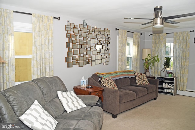 carpeted living area featuring ceiling fan