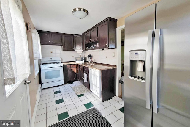 kitchen with tasteful backsplash, light tile patterned floors, dark brown cabinets, and stainless steel appliances