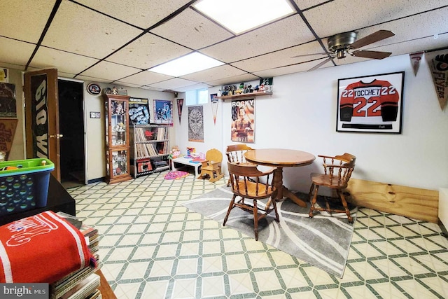 interior space with a paneled ceiling and light floors
