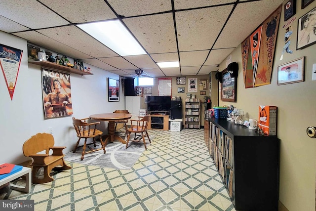dining room featuring a paneled ceiling and light floors