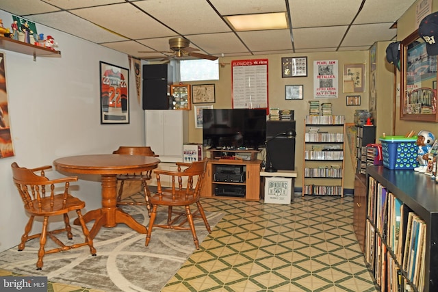 dining room featuring tile patterned floors and a drop ceiling