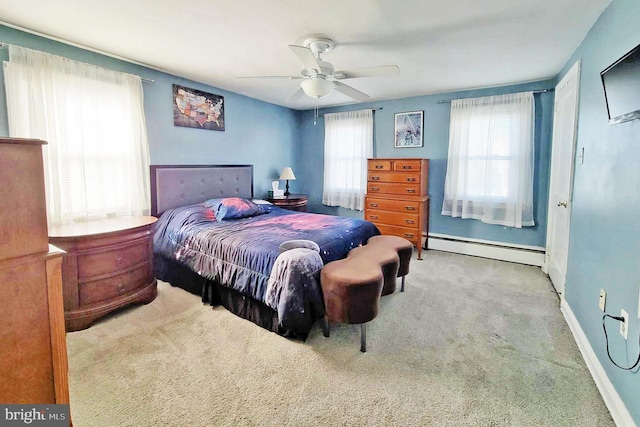 bedroom with baseboards, multiple windows, carpet flooring, and a baseboard heating unit