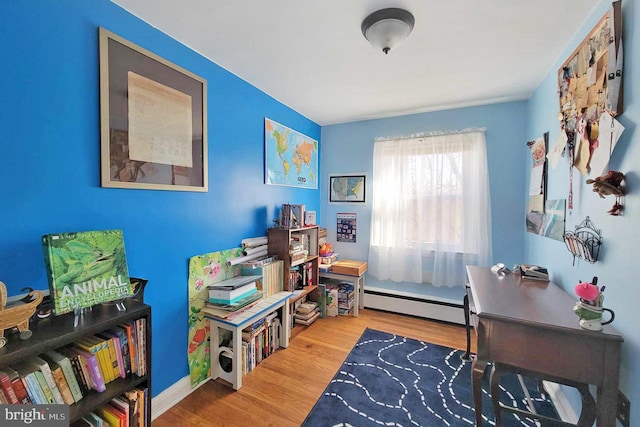 interior space with baseboard heating and wood finished floors