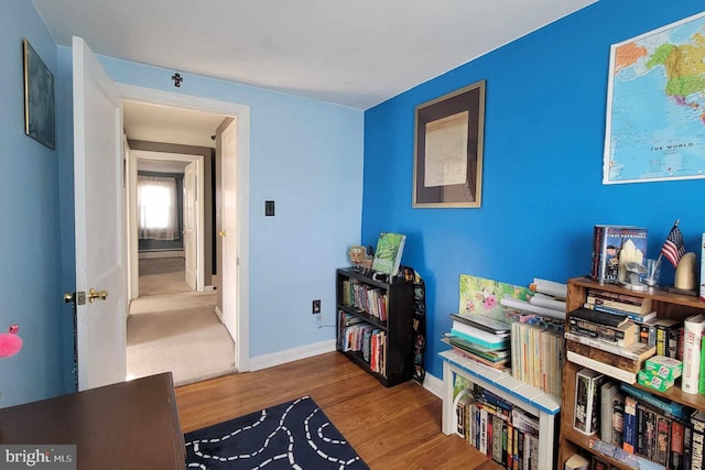 interior space featuring baseboards and wood finished floors