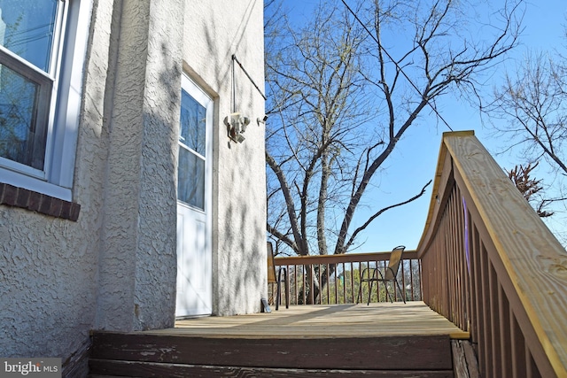 exterior space with a deck and stucco siding