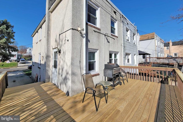 deck with grilling area and a residential view