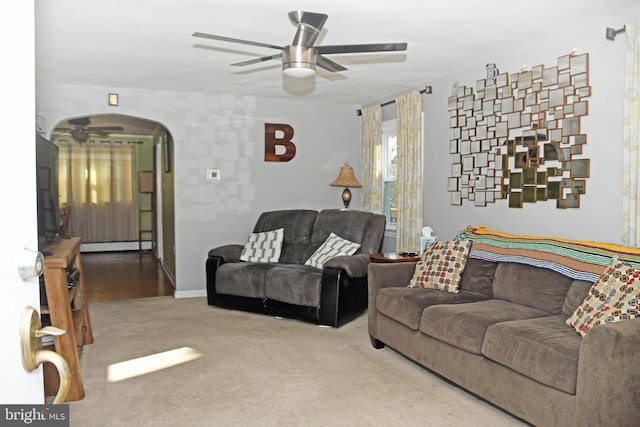 living room with arched walkways, a ceiling fan, and carpet