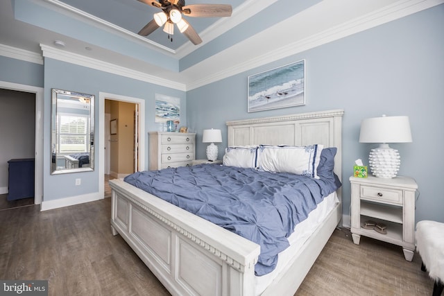 13115 Muirfield Ln, Berlin, MD 21811 - bedroom with baseboards, dark wood-style flooring, a tray ceiling, and crown molding