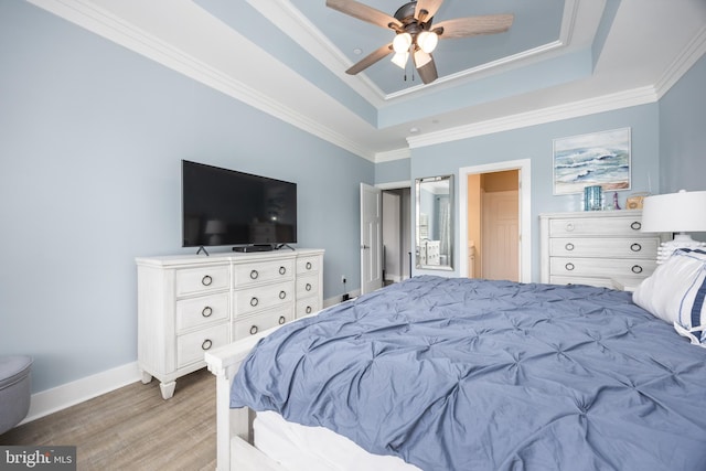 13115 Muirfield Ln, Berlin, MD 21811 - bedroom featuring baseboards, ornamental molding, ceiling fan, a tray ceiling, and light wood finished floors