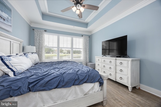 13115 Muirfield Ln, Berlin, MD 21811 - bedroom featuring baseboards, ornamental molding, a ceiling fan, a raised ceiling, and wood finished floors