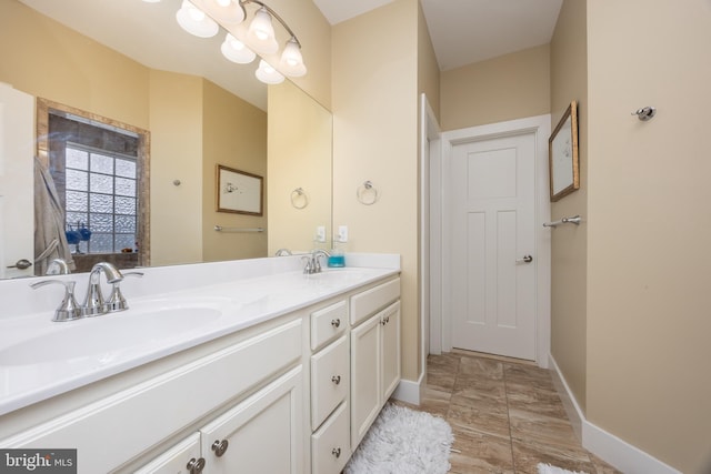 13115 Muirfield Ln, Berlin, MD 21811 - bathroom featuring a sink, baseboards, and double vanity