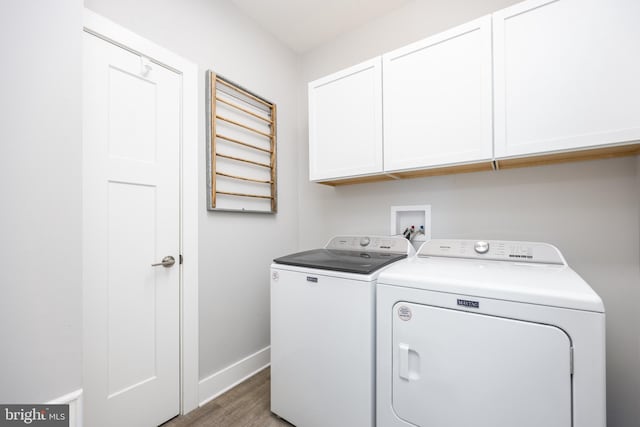 13115 Muirfield Ln, Berlin, MD 21811 - laundry area with light wood-type flooring, washing machine and clothes dryer, baseboards, and cabinet space
