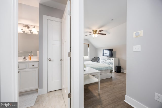 13115 Muirfield Ln, Berlin, MD 21811 - bedroom with light wood-style floors, a sink, baseboards, and vaulted ceiling