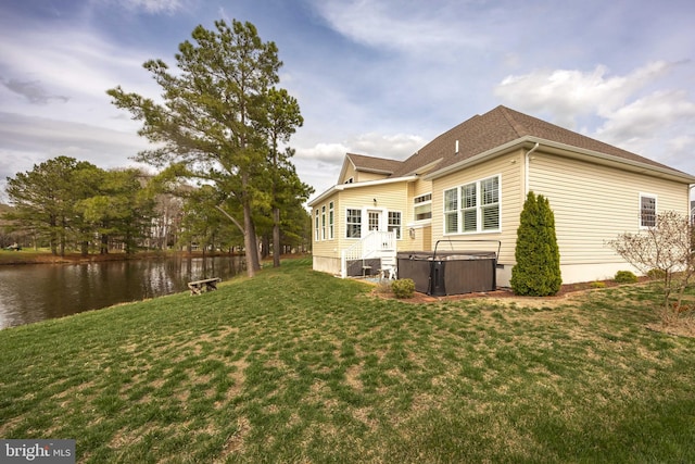 13115 Muirfield Ln, Berlin, MD 21811 - rear view of property with roof with shingles, a yard, a hot tub, and a water view