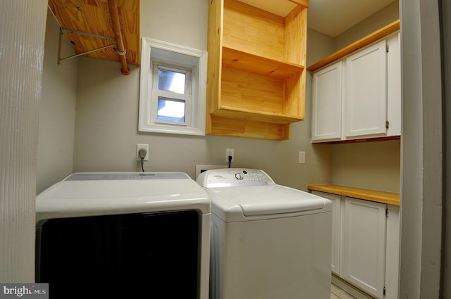 washroom with washer and dryer and cabinet space