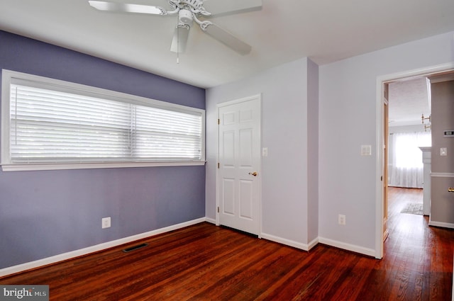 unfurnished bedroom with wood finished floors, visible vents, a ceiling fan, and baseboards