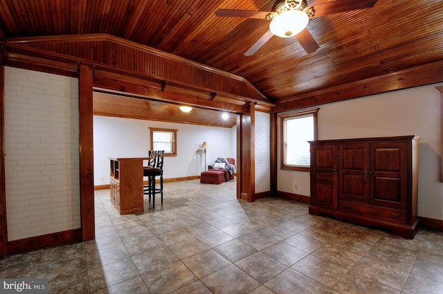 entryway featuring baseboards, vaulted ceiling, wood ceiling, and ceiling fan