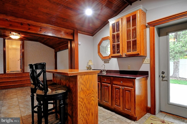 bar with lofted ceiling, wood ceiling, and light tile patterned flooring