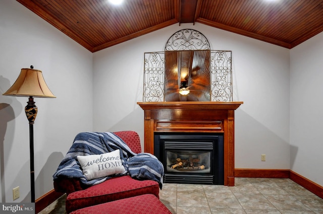 living area with lofted ceiling with beams, a glass covered fireplace, wooden ceiling, baseboards, and ornamental molding