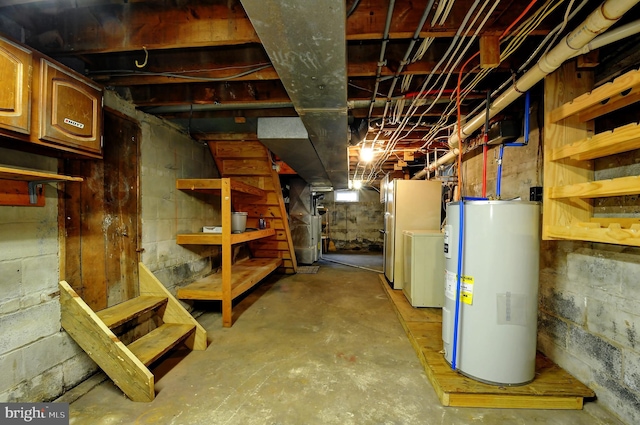 unfinished basement with electric water heater and washer / clothes dryer