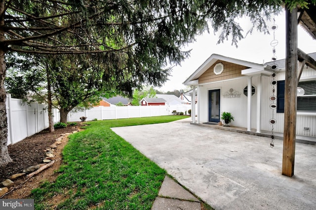view of yard featuring fence and a patio area