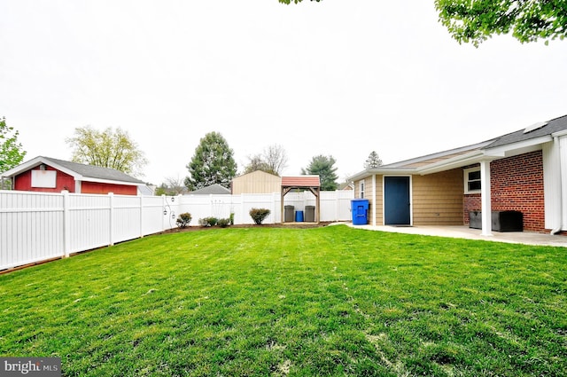 view of yard with a patio area and a fenced backyard