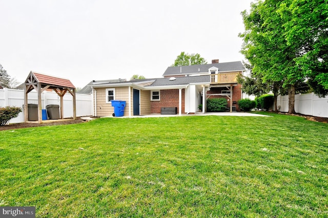 back of house featuring a fenced backyard, a gazebo, and a patio