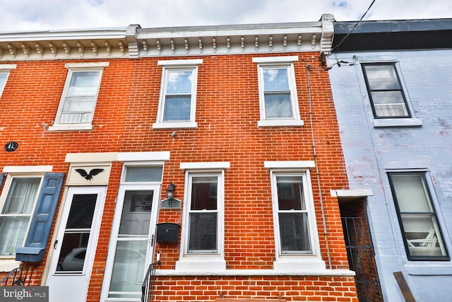 view of front of house featuring brick siding