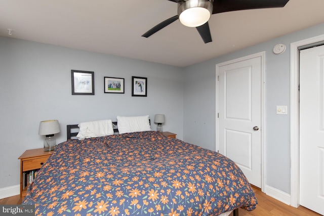 bedroom featuring baseboards, ceiling fan, and wood finished floors