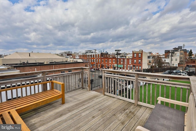 wooden terrace featuring a view of city