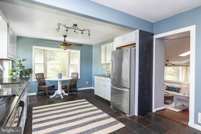 7012 Lancaster Rd, Baltimore, MD 21207 - kitchen featuring stainless steel appliances, white cabinetry, and ceiling fan