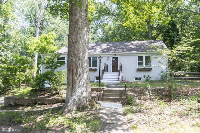 7012 Lancaster Rd, Baltimore, MD 21207 - view of front of home with stucco siding and roof with shingles