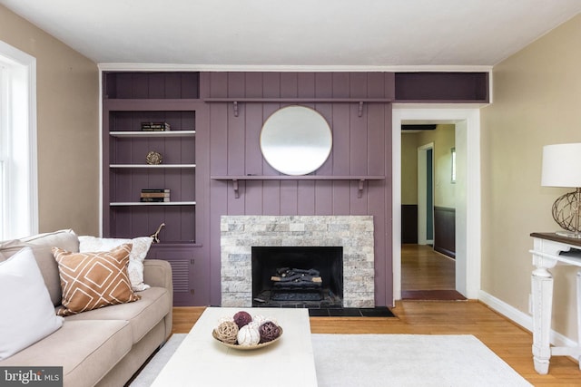 7012 Lancaster Rd, Baltimore, MD 21207 - living room with wood finished floors, built in shelves, and a fireplace with flush hearth